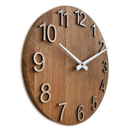 Drevené hodiny so symetrickým tvarom a výrezom inšpirovaným motívmi z prírody.